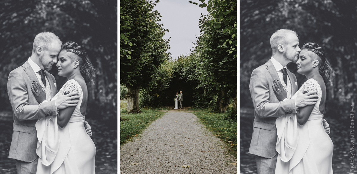 Wedding_Photoshoot_2021_at_ängsö_slott_under_arch_hugging_bride_in_white_dress_groom_in_grey_suit